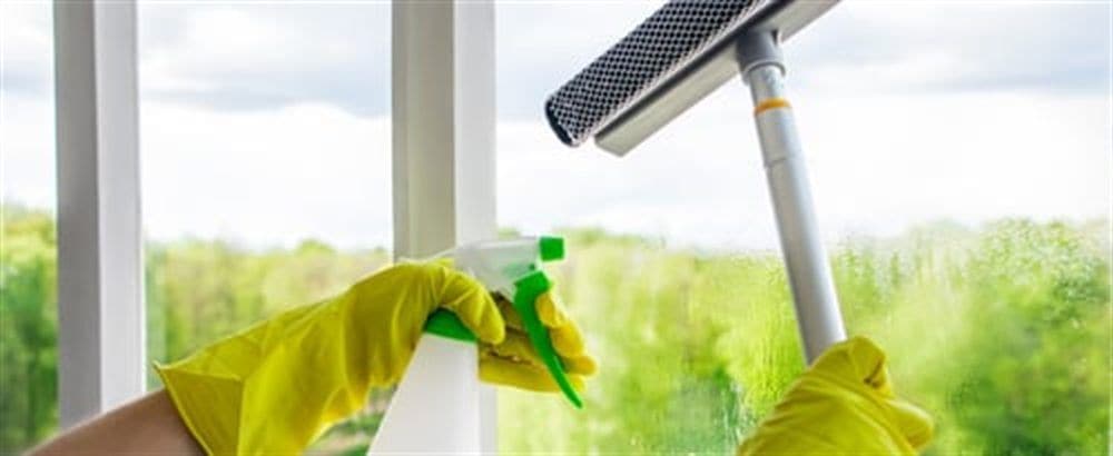 Squeegee leaving a streak-free finish on a window during AHC cleaning service