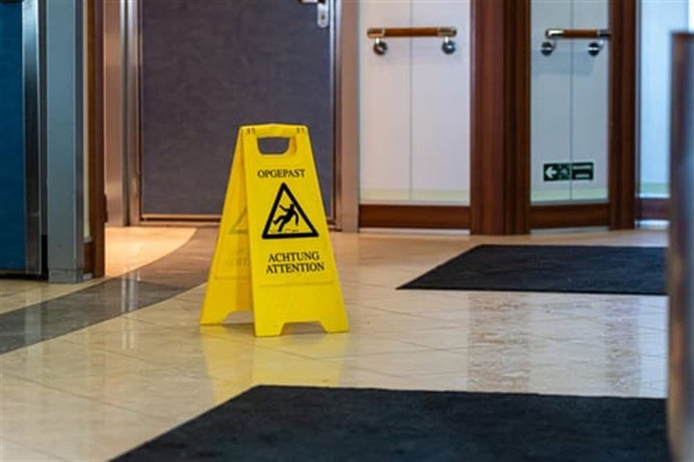 Commercial corridor with wet floor sign during AHC recurring janitorial service in Illinois